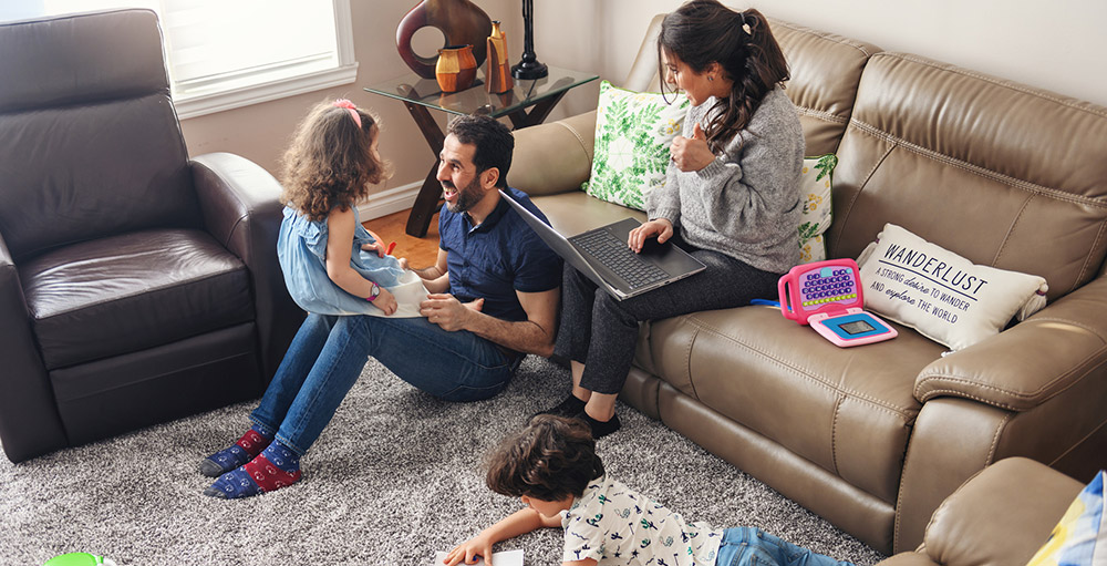 Family In Air Conditioned Living Room