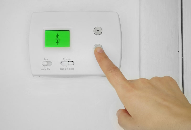 malfunctioning thermostat displaying dollar sign